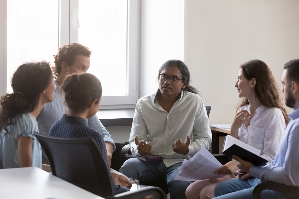 Man sharing own lived experience with colleagues